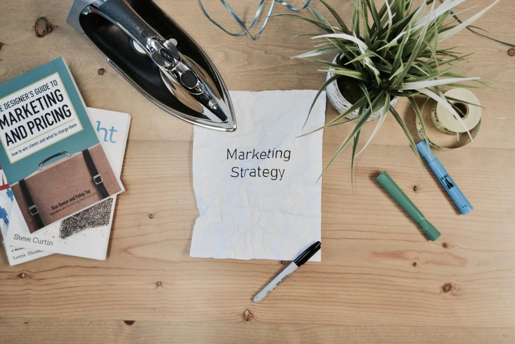 Table with marketing books and a plant